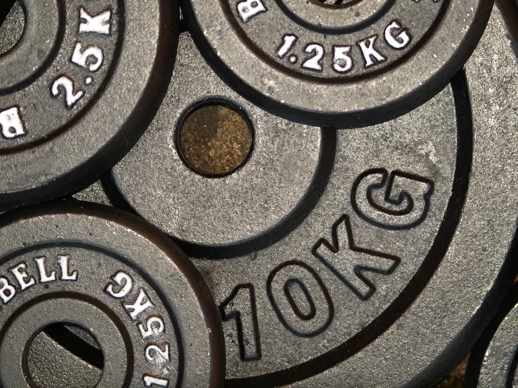 Stacked cast-iron weight plates stamped with their weights